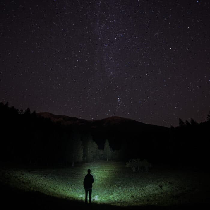Man walking under a starry night