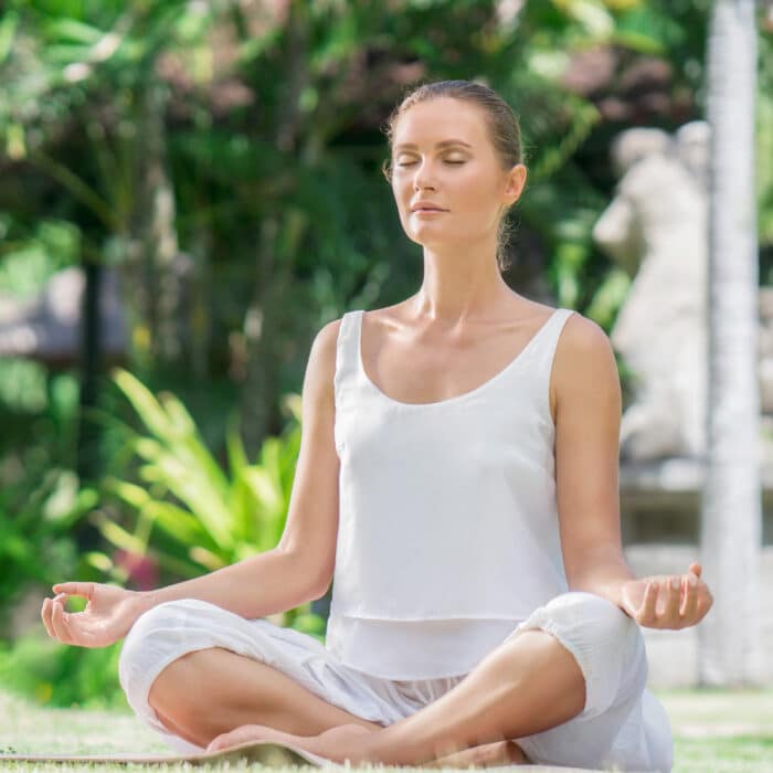 Young woman doing yoga meditation outdoors