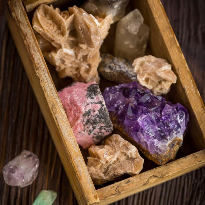 Collection of decorative stones and minerals in a small wooden box