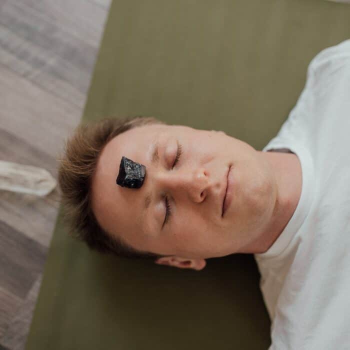 person with black crystal on his forehead