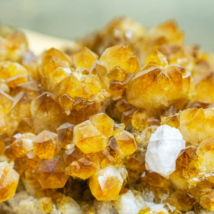 Raw specimen of quartz crystal stone. Citrine yellow gem crystals geological mineral background. Selective focus