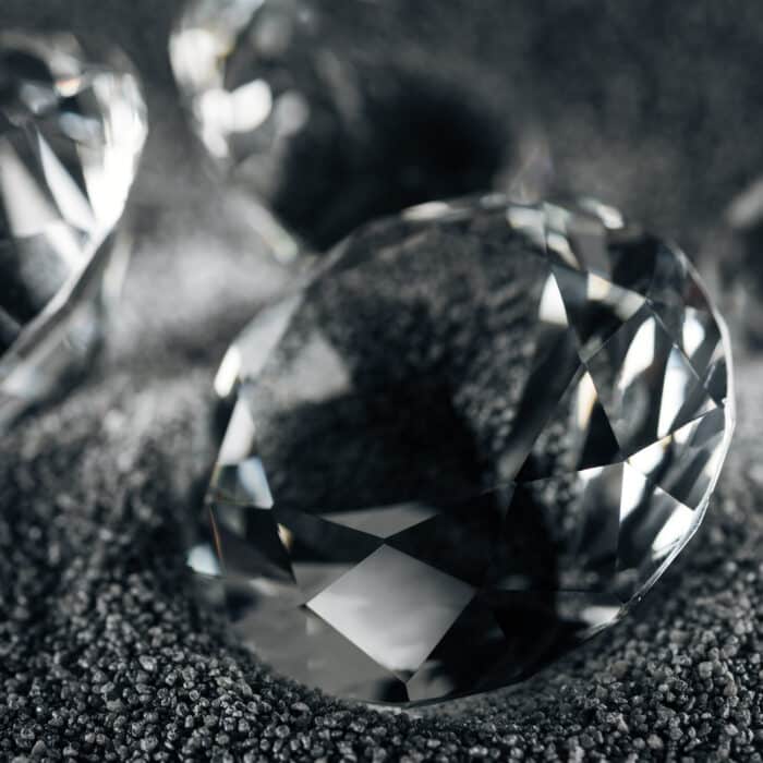 Close up of transparent diamonds on grey textured background