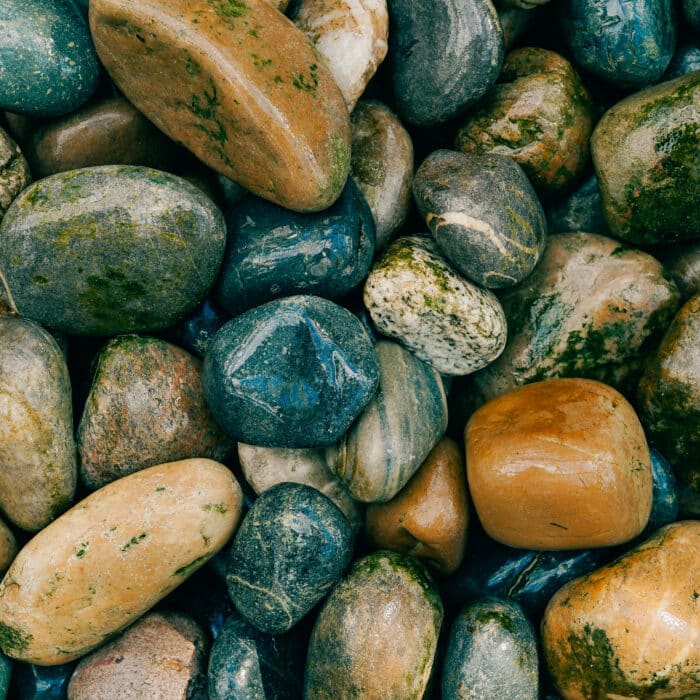Colorful smooth stones on the shore. Backgroung with rocks.
