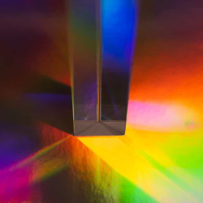 Glass prism on bright rainbow colors abstract background. Colorful polygonal multicolor banner. High quality photo