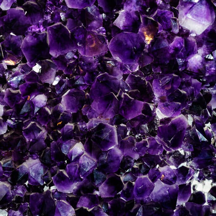 Backgrounds and textures: druse of beautiful purple amethyst crystals, semiprecious stone, natural abstract background
