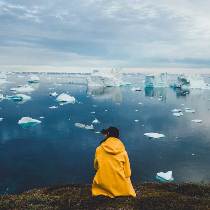 Woman in yellow hooded coat in Greenland