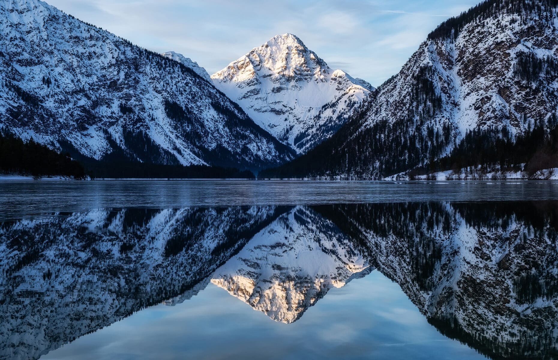 Landscape in Austria. Mountains and reflections in the lake. Winter season.