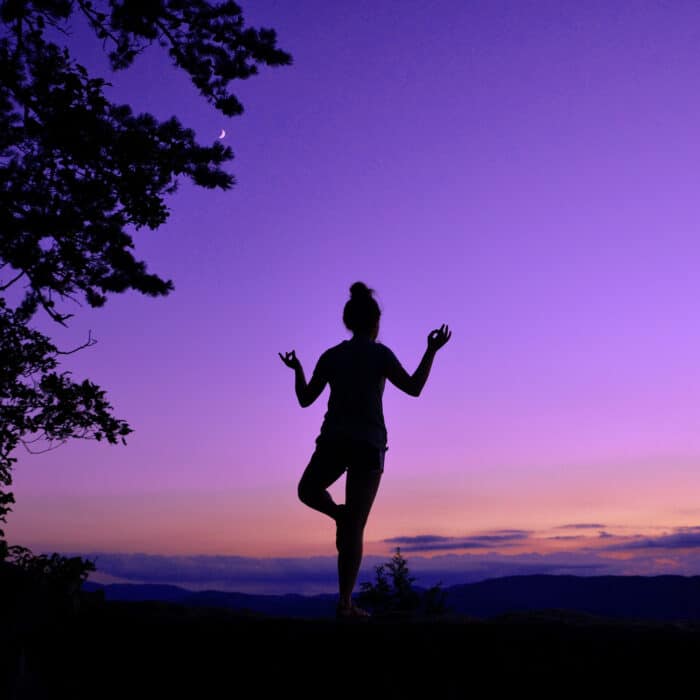 Woman doing yoga purple skies