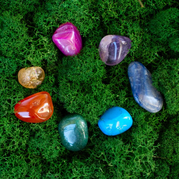 Healing crystals set rainbow circle on moss background, magic healing Rock for Reiki Crystal Ritual, Witchcraft, spiritual esoteric practice