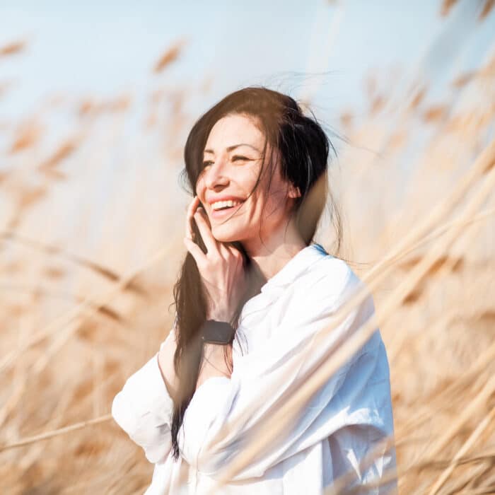 Woman smiling in a nature background