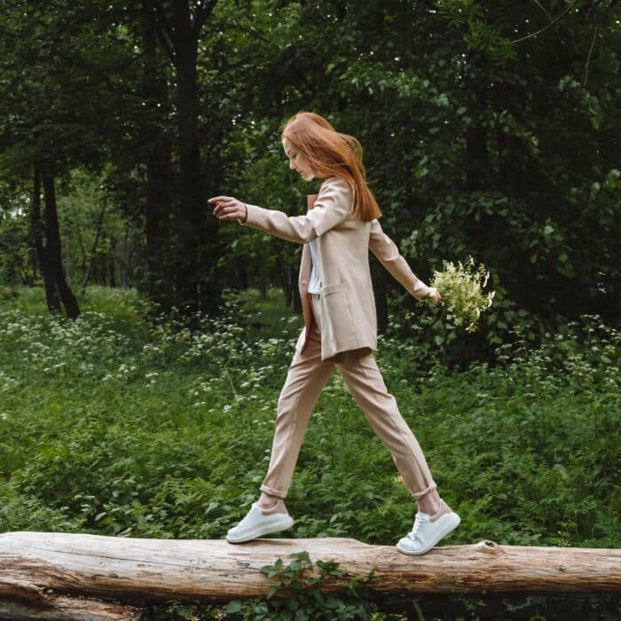 Stress and resilience. Spend Time in Nature to Reduce Stress and Anxiety. Nature break relieves stress. Young woman in suit enjoying nature and walking in green summer park.