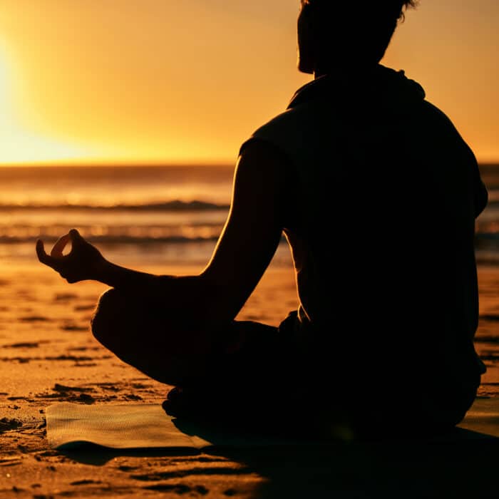 Yoga, lotus and silhouette of man at beach outdoors for health and wellness. Sunset, zen meditation.