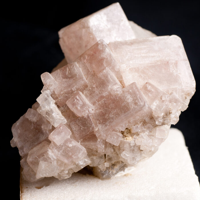 Pinkish white halite crystal mineral sample, rock salt