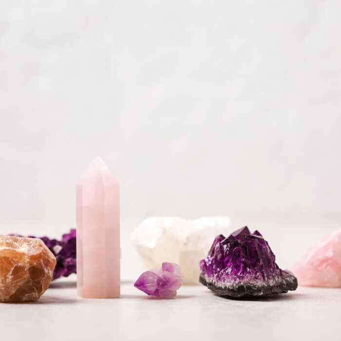 Healing reiki chakra crystals over fabric background. Gemstones for wellbeing, harmony, meditation, relaxation, metaphysical, spiritual practices. Energetical power concept