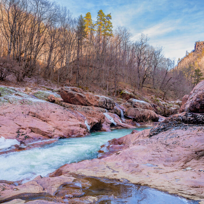 Beautiful winter landscape with turquoise mountain river and granite canyon